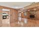 Open-concept living room and kitchen area with a fireplace at 10213 Newport Cir, Tampa, FL 33612