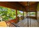 Screened porch with wooden swing and view of the backyard at 10213 Newport Cir, Tampa, FL 33612