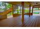 Spacious screened porch with wooden deck and stairs at 10213 Newport Cir, Tampa, FL 33612