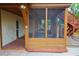 Spacious screened porch with wooden flooring, ceiling fan, and outdoor furniture at 10213 Newport Cir, Tampa, FL 33612