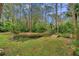 Small pond with a wooden footbridge, surrounded by tranquil greenery at 655 Appaloosa Rd, Tarpon Springs, FL 34688