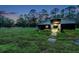 Rustic barn with open-air stalls and fenced pasture at 655 Appaloosa Rd, Tarpon Springs, FL 34688