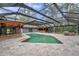 Expansive pool and patio area with covered lanai at 655 Appaloosa Rd, Tarpon Springs, FL 34688