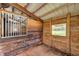 Simple horse stall with wood walls and window at 655 Appaloosa Rd, Tarpon Springs, FL 34688