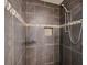 Modern shower with gray tile and mosaic accents at 655 Appaloosa Rd, Tarpon Springs, FL 34688