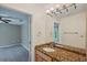 Bathroom with granite vanity, single sink, and built-in shelving at 655 Appaloosa Rd, Tarpon Springs, FL 34688