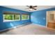 Blue bedroom with large windows, ceiling fan and access to closet at 655 Appaloosa Rd, Tarpon Springs, FL 34688