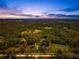 Wide aerial view of expansive property at sunset at 655 Appaloosa Rd, Tarpon Springs, FL 34688
