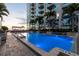 Night view of resort-style pool with lounge chairs and city views at 777 N Ashley Dr # 806, Tampa, FL 33602