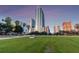 Modern high-rise building with a lush green space in front at 777 N Ashley Dr # 806, Tampa, FL 33602