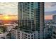 Aerial view of a highrise building with rooftop pool and city views at sunset at 777 N Ashley Dr # 806, Tampa, FL 33602