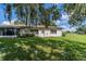 Rear view of house with large oak tree at 2535 Lancaster Dr # 2535, Sun City Center, FL 33573
