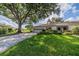Front view of house with driveway and landscaping at 2535 Lancaster Dr # 2535, Sun City Center, FL 33573
