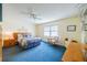 Main bedroom features a king bed, dresser, and blue carpet at 2535 Lancaster Dr # 2535, Sun City Center, FL 33573