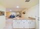 Kitchen with white cabinets and view into living room at 2535 Lancaster Dr # 2535, Sun City Center, FL 33573