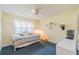 Cozy bedroom with daybed, TV, and window offering natural light at 2535 Lancaster Dr # 2535, Sun City Center, FL 33573