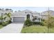 One-story home with gray garage door and landscaping at 43198 Boardwalk Loop, Punta Gorda, FL 33982