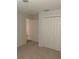 Bedroom with double door closet and view into another room at 12245 Cypress Branch St, Riverview, FL 33579