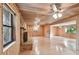 Spacious living room with wood paneling, hardwood floors, and a stone fireplace at 10213 Newport Cir, Tampa, FL 33612