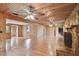 Large living room with hardwood floors, wood paneling and a fireplace at 10213 Newport Cir, Tampa, FL 33612