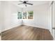 Bedroom with wood-look floors, ceiling fan and large window at 3457 22Nd S Ave, St Petersburg, FL 33711