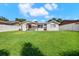 Fenced backyard with covered patio and lush green lawn at 10248 Oakhaven Dr, Pinellas Park, FL 33782