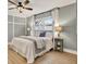 Tranquil bedroom featuring a comfortable bed, wood floors, and calming color scheme at 10248 Oakhaven Dr, Pinellas Park, FL 33782