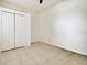 Bedroom with neutral walls, tile flooring and closet with doors at 3232 Gianna Way, Land O Lakes, FL 34638