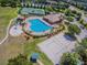 Aerial view of the community pool, sand volleyball court, and splash pad at 3232 Gianna Way, Land O Lakes, FL 34638