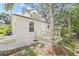 Beautiful backyard with a deck, lush landscaping, and a charming home exterior at 6907 N 20Th St, Tampa, FL 33610