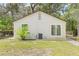 Home's exterior features a small deck, modern siding, and a well-maintained lawn in the backyard at 6907 N 20Th St, Tampa, FL 33610