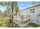 Backyard with a deck, lush landscaping, and a welcoming entryway at 6907 N 20Th St, Tampa, FL 33610