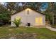 Home's exterior features a small deck, modern siding, and a well-maintained lawn in the backyard at 6907 N 20Th St, Tampa, FL 33610