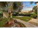 View of backyard features tropical landscaping, shed, concrete pad and well-maintained lawn at 6907 N 20Th St, Tampa, FL 33610