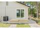 Backyard featuring a home, a deck, a sliding glass door, and landscaping at 6907 N 20Th St, Tampa, FL 33610