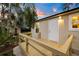 Back porch and backyard showcasing exterior lighting and wooden deck with railing at 6907 N 20Th St, Tampa, FL 33610