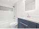 Bathroom featuring a tub and shower combination with tile surround and vanity with modern finishes at 6907 N 20Th St, Tampa, FL 33610