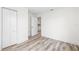 Well-lit bedroom with wood-look flooring and a closet, offering ample storage space at 6907 N 20Th St, Tampa, FL 33610