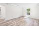 Spacious room with recessed lights, hardwood floors and large window at 6907 N 20Th St, Tampa, FL 33610