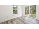Bright bedroom with sliding glass doors and a window overlooking lush greenery at 6907 N 20Th St, Tampa, FL 33610