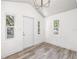 Inviting entryway with wood-look floors, recessed lighting, and a stylish chandelier at 6907 N 20Th St, Tampa, FL 33610