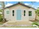 Charming cottage-style home featuring a light blue front door and neutral siding at 6907 N 20Th St, Tampa, FL 33610