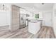 Bright kitchen featuring stainless steel appliances, a stylish island, and sleek white cabinetry at 6907 N 20Th St, Tampa, FL 33610