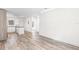 Open floorplan, bright living space featuring wood-look floors and recessed lighting at 6907 N 20Th St, Tampa, FL 33610