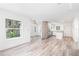 Bright living room with hardwood floors flowing into an open kitchen with stainless steel appliances at 6907 N 20Th St, Tampa, FL 33610