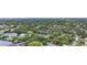 Aerial view of a waterfront community with lush trees and various houses at 4915 W Melrose N Ave, Tampa, FL 33629