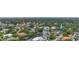 An aerial view showcasing a house on the waterfront in a tree-lined neighborhood at 4915 W Melrose N Ave, Tampa, FL 33629