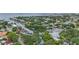 Aerial view showcasing a waterfront community with lush green spaces and canals at 4915 W Melrose N Ave, Tampa, FL 33629