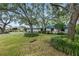 Ranch-style home with mature trees and landscaping at 4915 W Melrose N Ave, Tampa, FL 33629