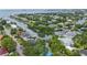 Aerial view of waterfront homes and lush landscaping with a calm canal at 4915 W Melrose N Ave, Tampa, FL 33629